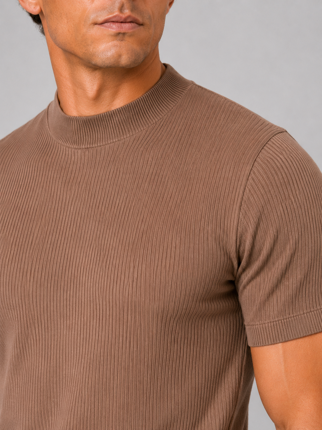 Close up of brown ribbed t shirt showing soft stretch fabric and mock neck detail