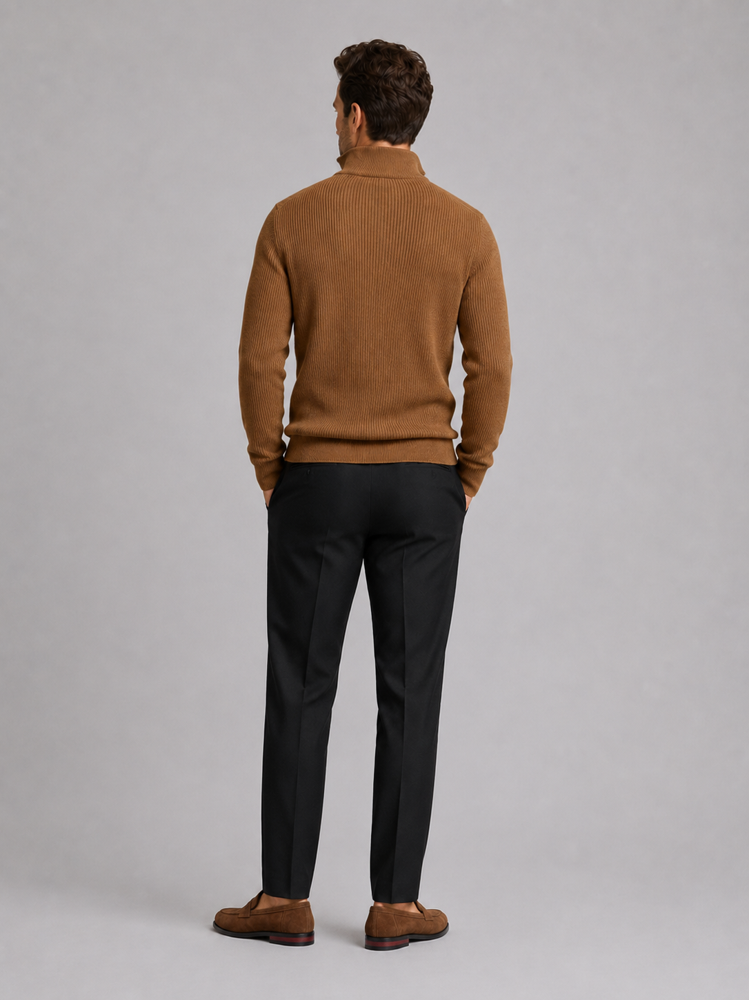 Back view of a man wearing a brown quarter zip sweater showing the slim fit, long sleeves, and clean knit finish