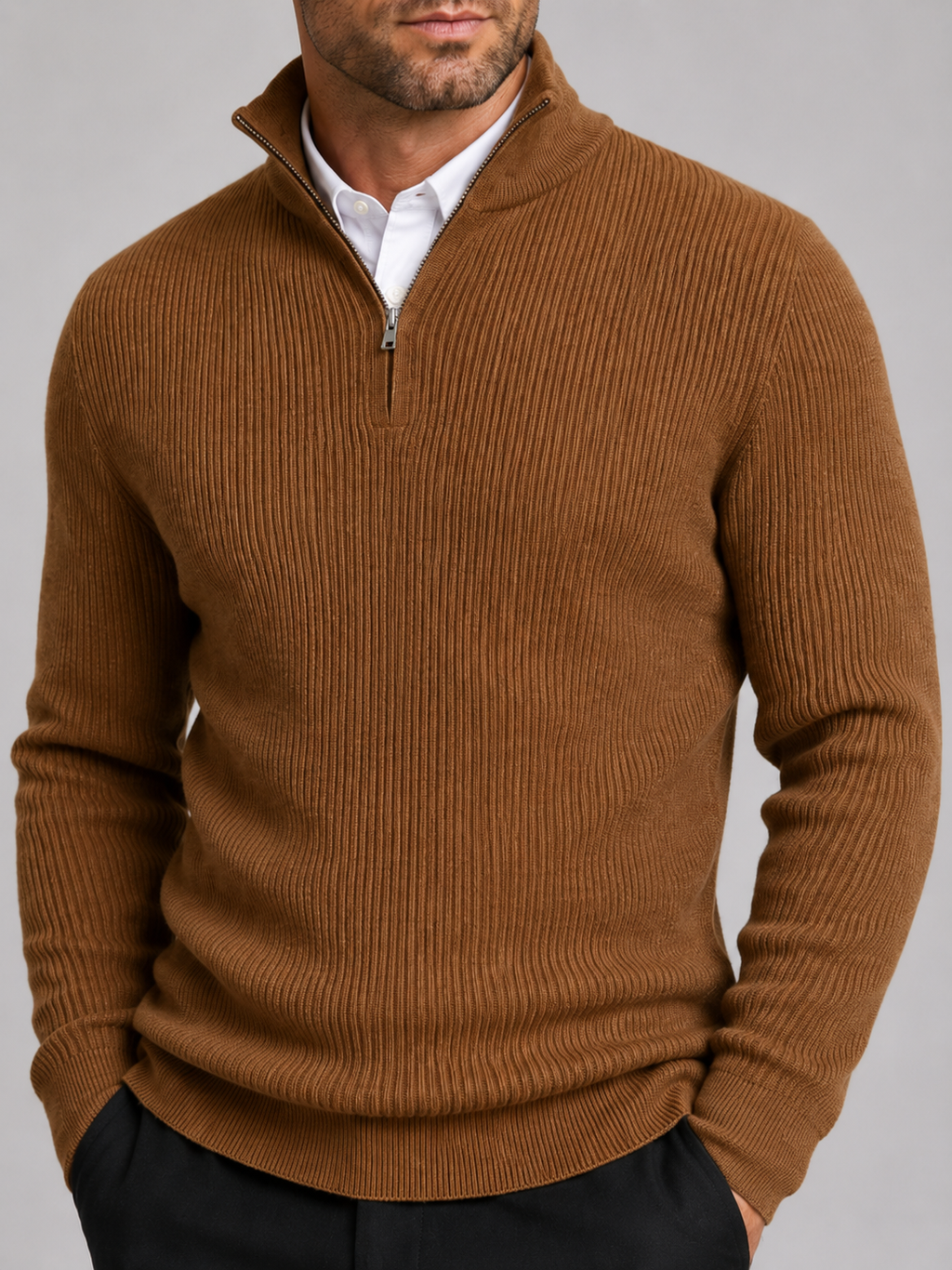 Close-up of a brown quarter zip sweater showing the warm knit texture, mock neck, zipper, cuffs, and stitching