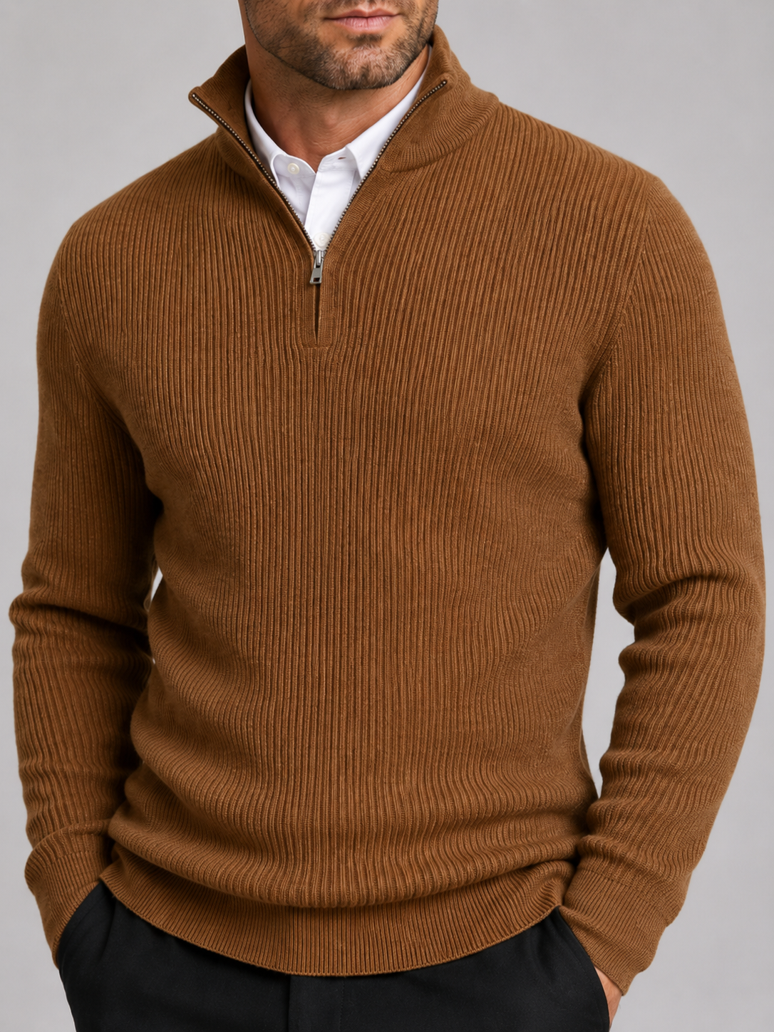 Close-up of a brown quarter zip sweater showing the warm knit texture, mock neck, zipper, cuffs, and stitching