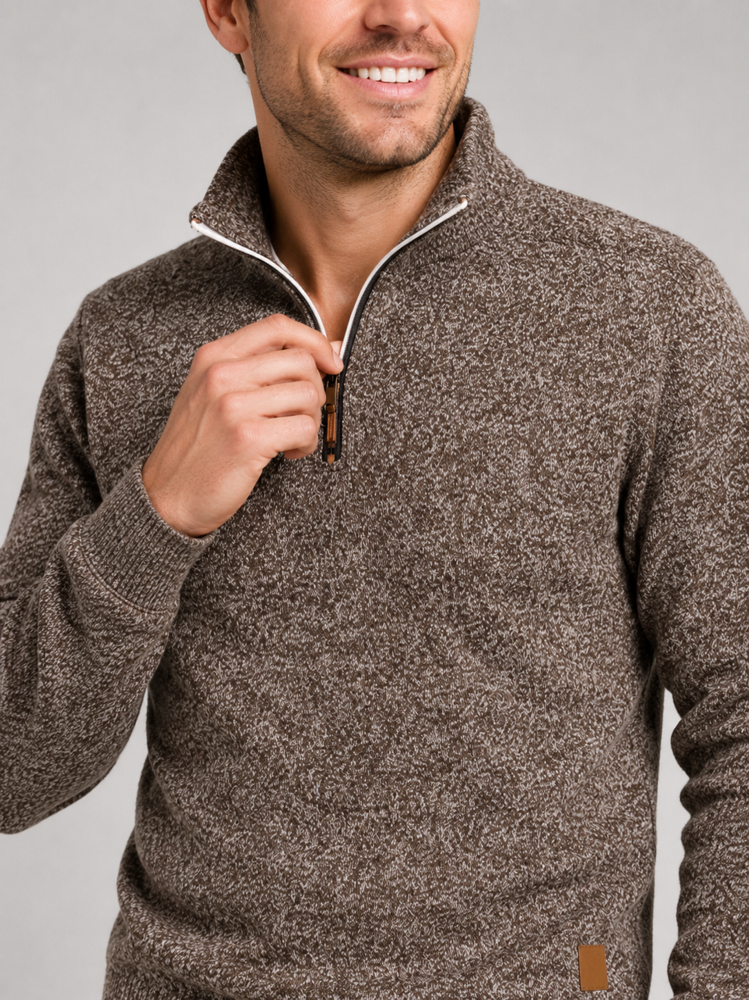 Close up of brown quarter zip sweater showing soft knit texture and stand collar zipper detail