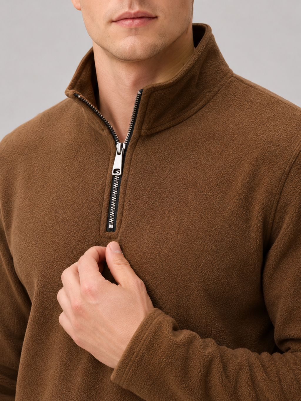Close up of brown fleece pullover showing soft thermal fabric and quarter zip mock neck detail