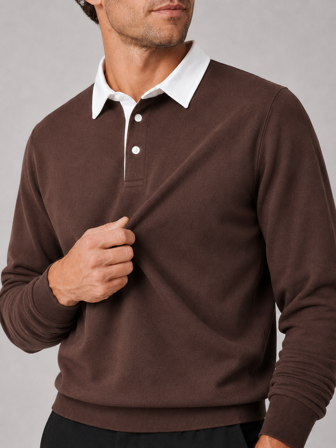 Close up of brown rugby polo shirt showing soft knit fabric and classic collar detail