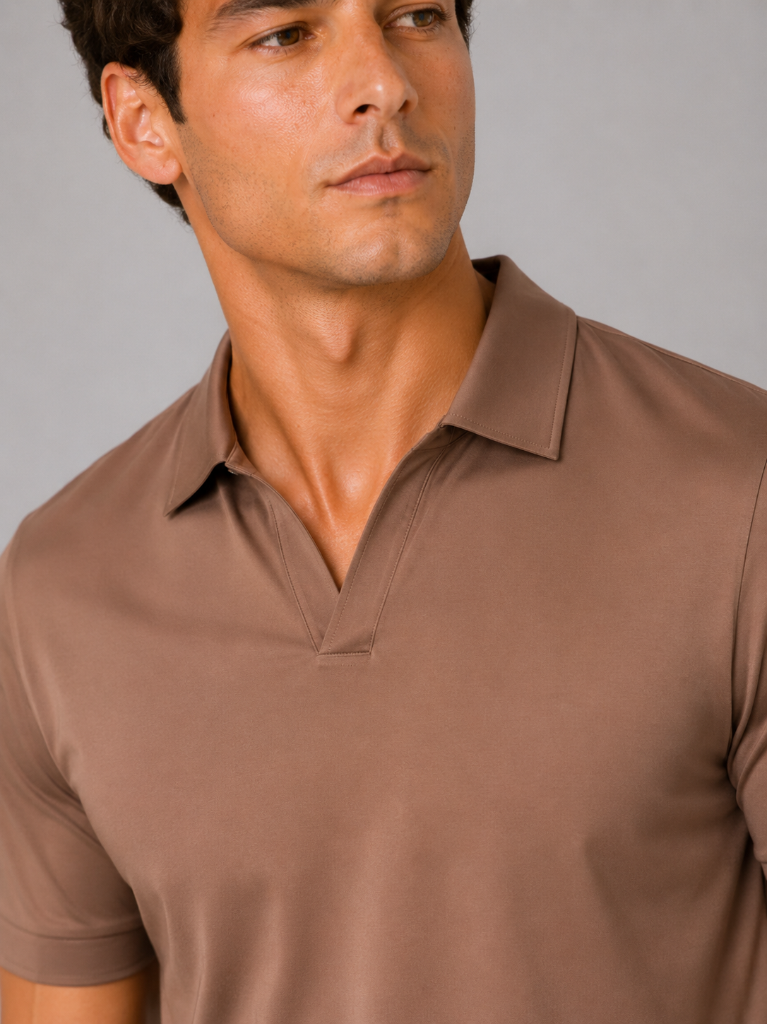 Close up of brown polo shirt showing smooth silky fabric and refined collar detail