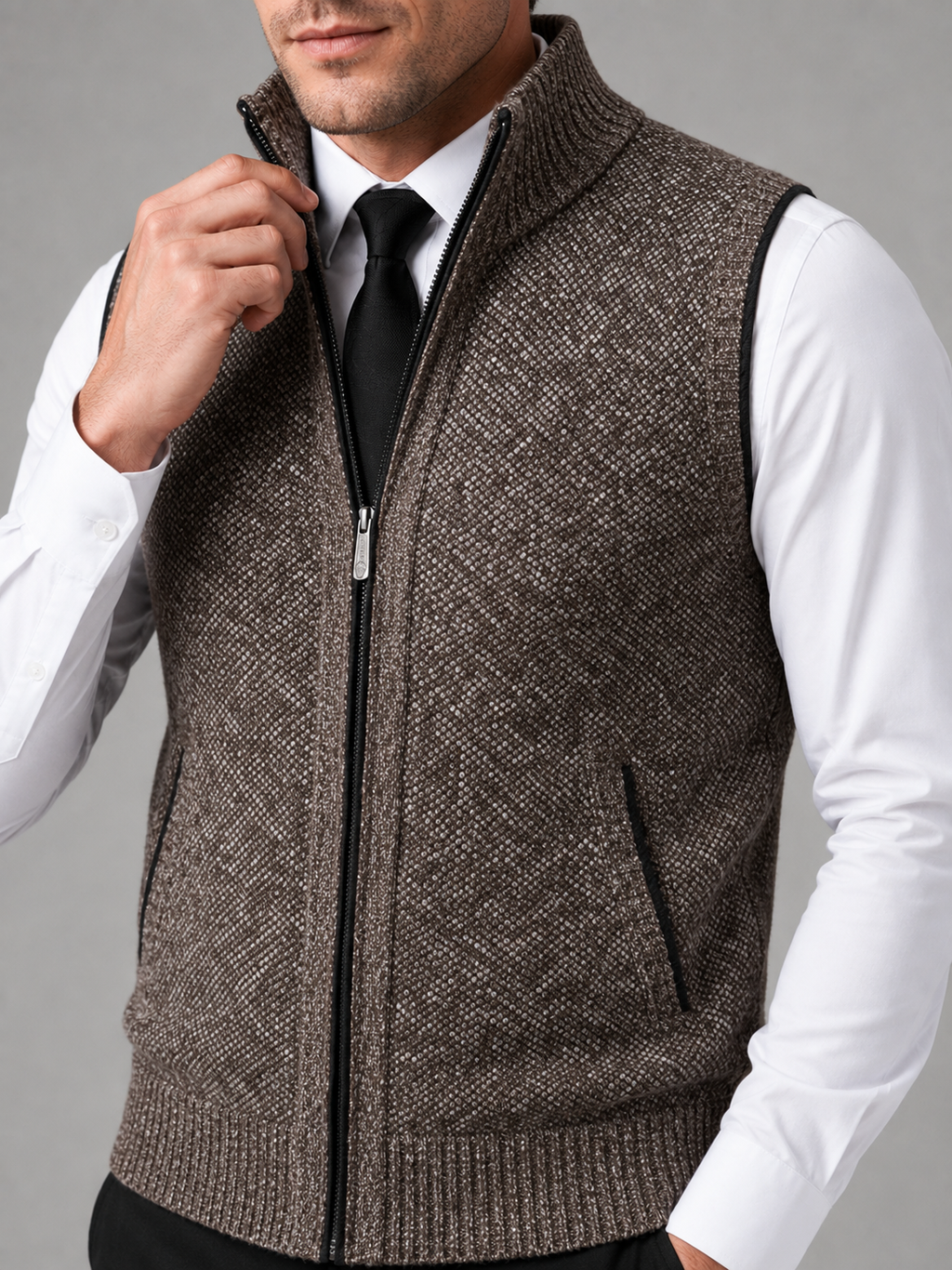Close up of brown full zip sweater vest showing soft knit texture and stand collar zipper detail
