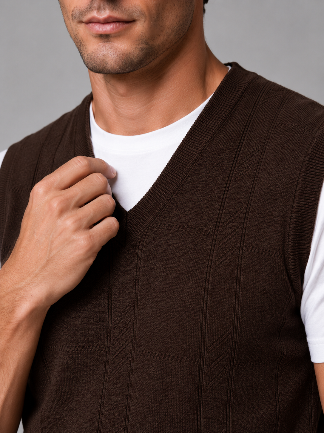 Close up of brown sweater vest showing soft knit texture and classic v neck detail