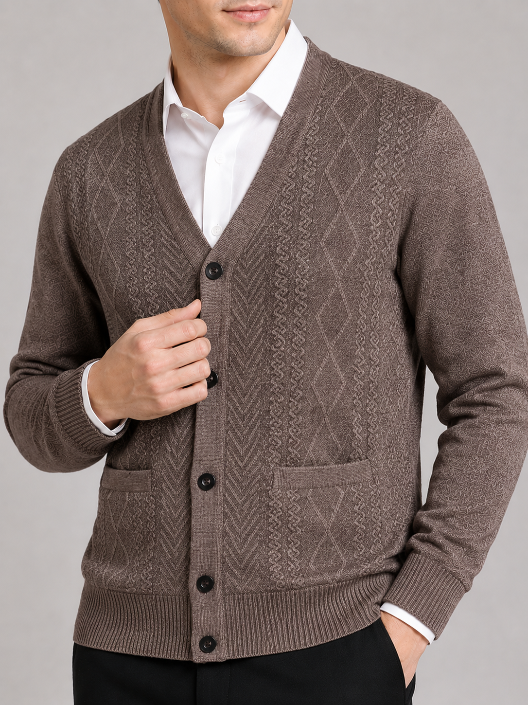 Close up of brown knit cardigan showing soft textured fabric and refined button front detail