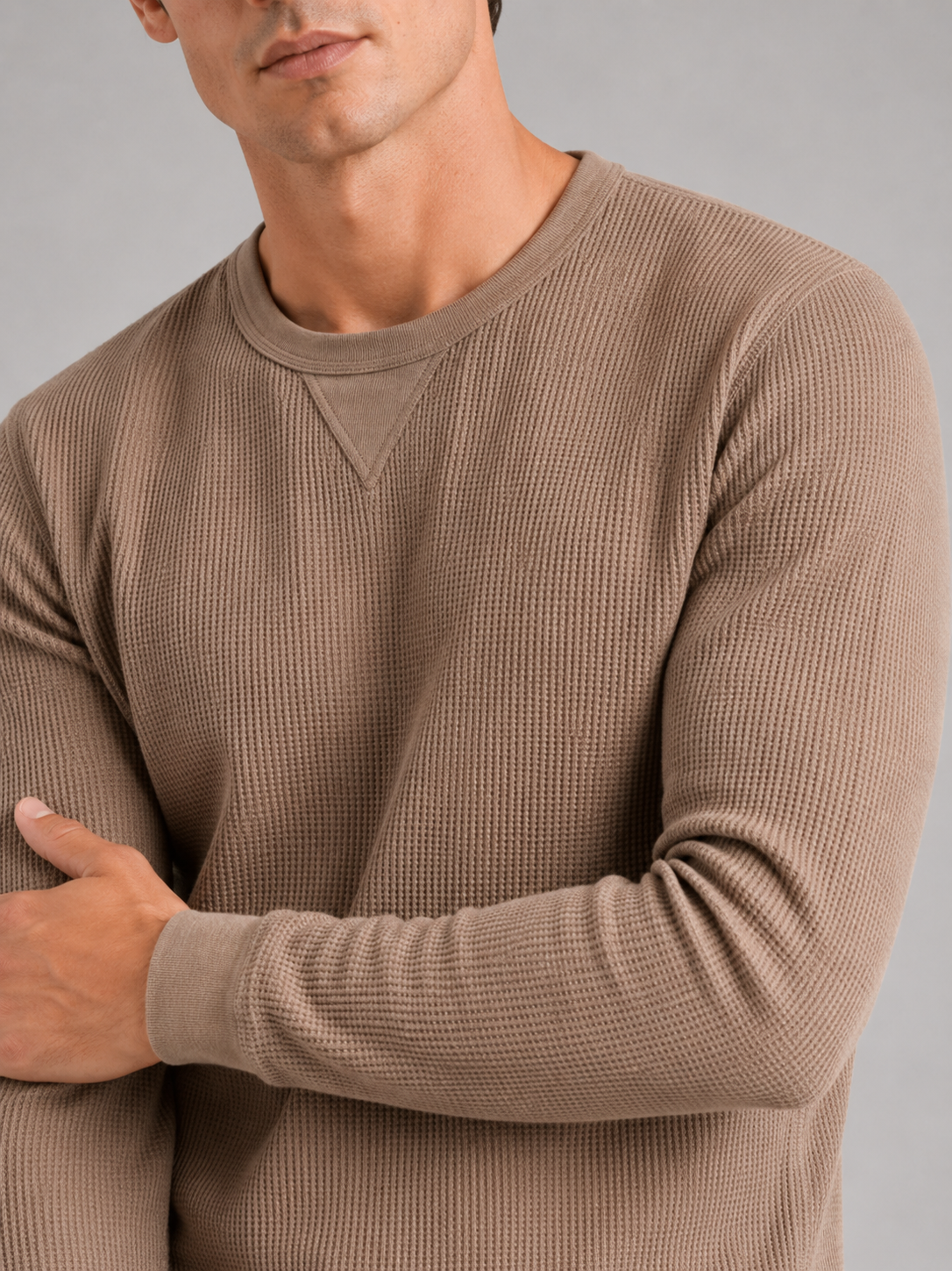 Close up of brown waffle knit shirt showing textured thermal fabric and soft knit detail