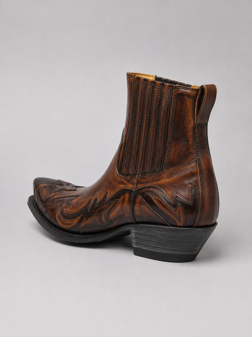 Back view of brown men’s western cowboy boots showing embroidered details, pull tabs, heel, and durable outsole