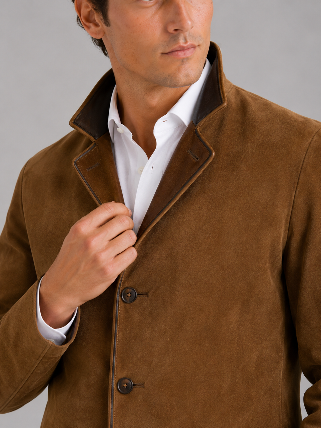 Close up of brown workwear jacket showing contrast color details and durable fabric texture