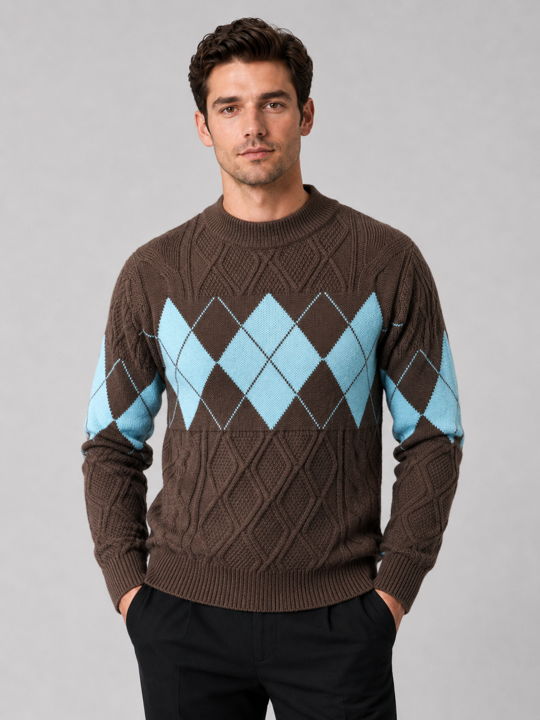 Front view of a man wearing a brown argyle cable knit sweater with a mock neck, patchwork design, long sleeves, and warm knit construction