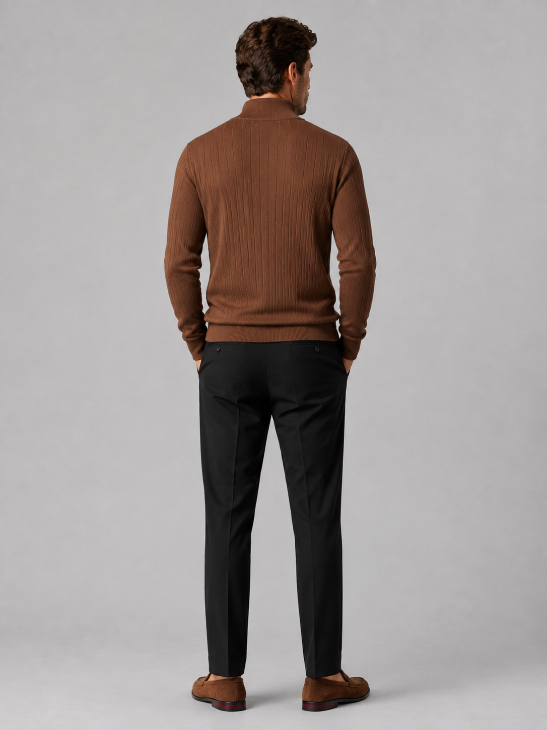 Back view of a man wearing a brown quarter zip sweater showing the long sleeves, clean knit construction, and comfortable fit