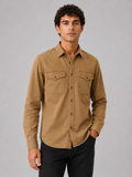 Men wearing brown cotton washed work shirt long sleeve double pocket casual button up style