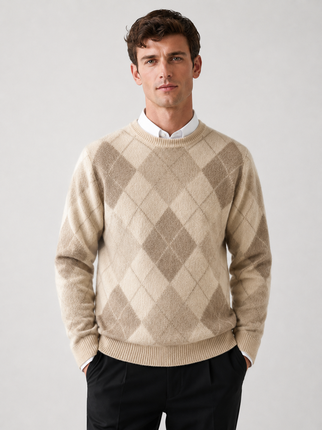 Front view of a man wearing a brown wool argyle sweater with a crew neck, long sleeves, and thick warm knit construction
