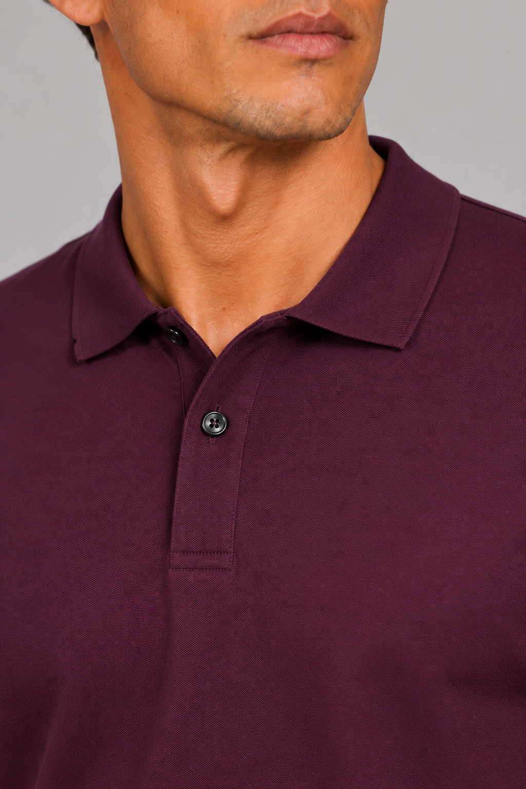 Close up of burgundy polo shirt showing smooth silk touch fabric and refined collar detail