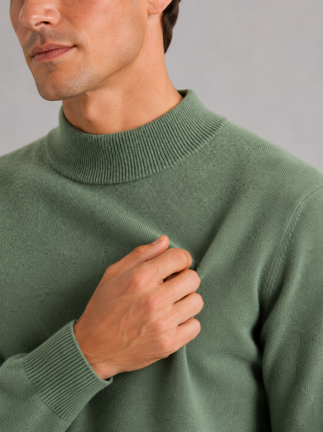 Close up of green wool mock neck sweater showing soft premium knit texture and refined collar detail