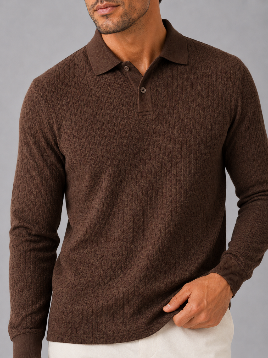 Close up of coffee knit polo shirt showing soft textured fabric and refined collar detail