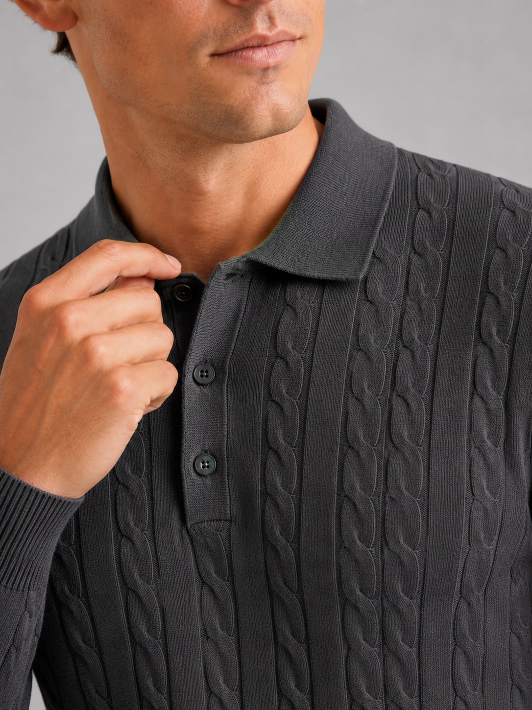 Close up of dark gray cable knit polo showing soft textured fabric and refined collar detail