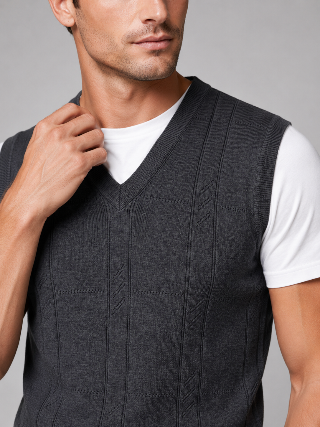 Close up of dark gray sweater vest showing soft knit texture and classic v neck detail