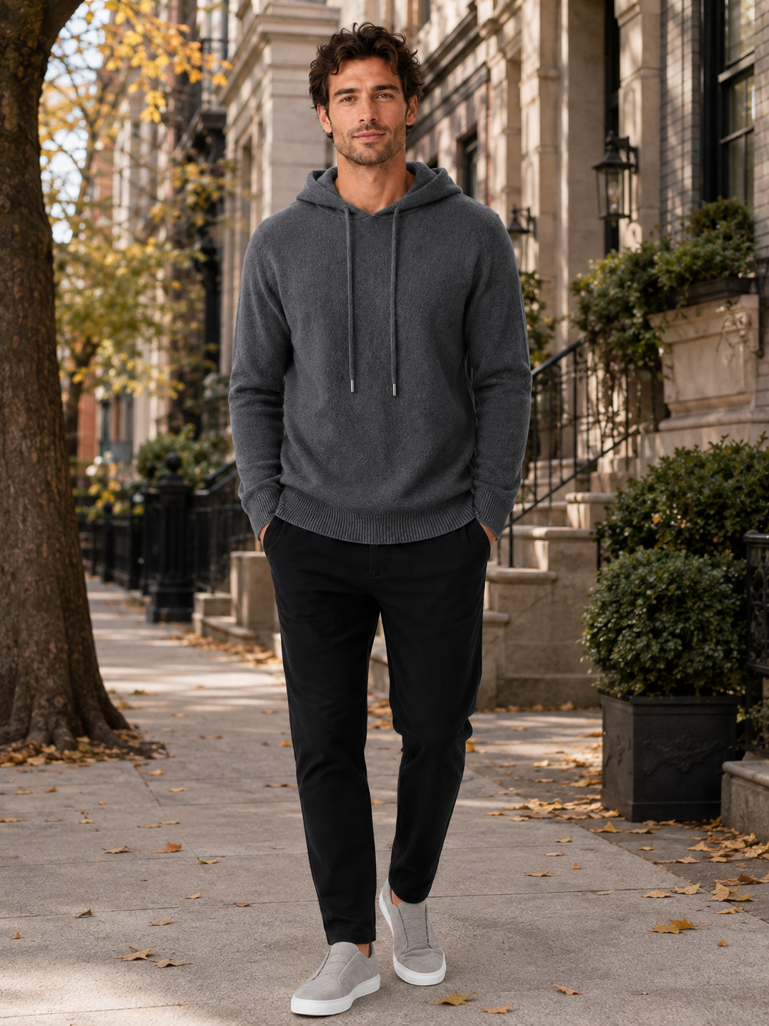 Man wearing a dark gray wool hoodie sweater in a casual fall winter outfit for everyday wear