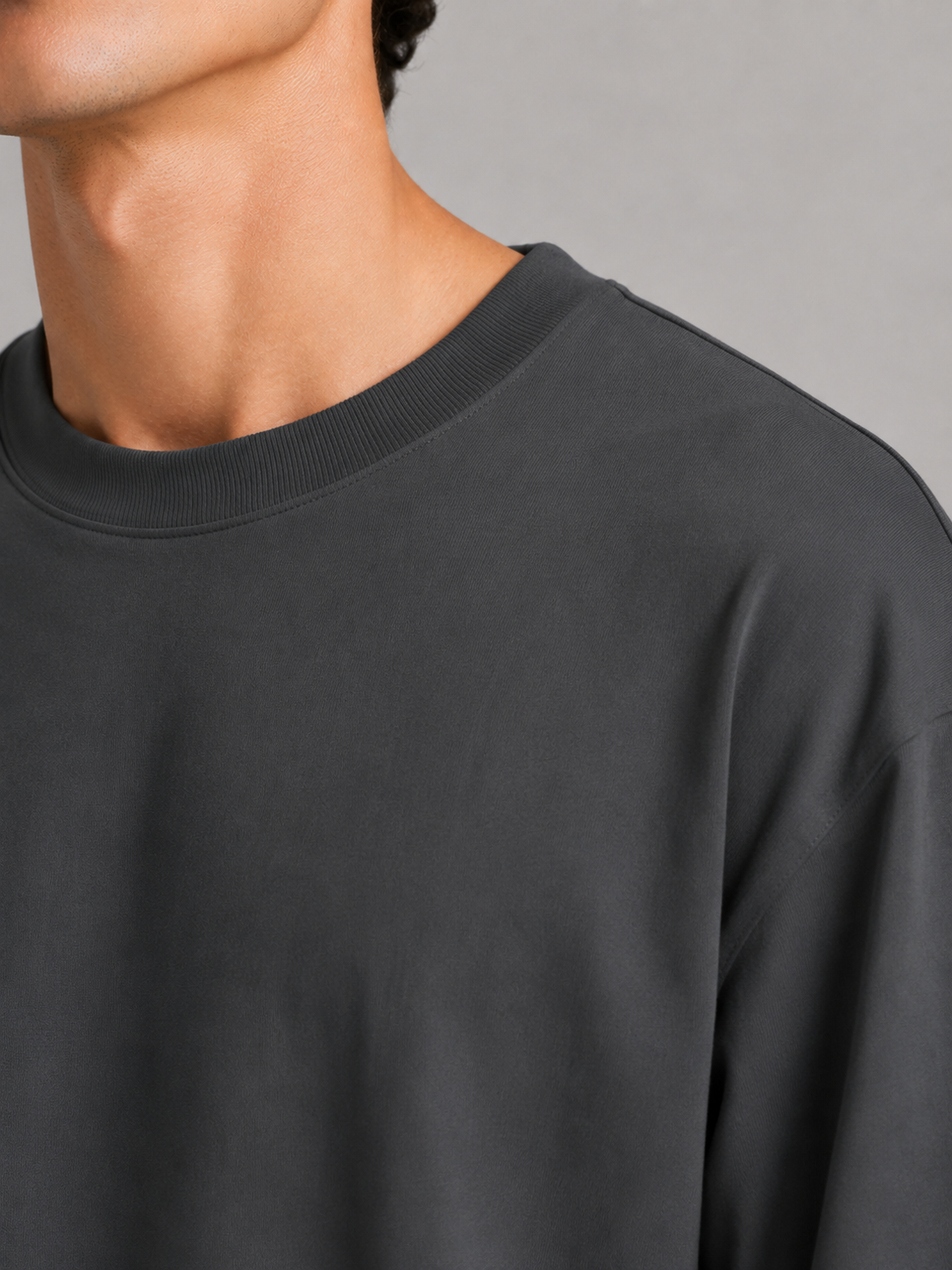 Close up of dark grey t shirt fabric showing soft lightweight breathable cotton texture