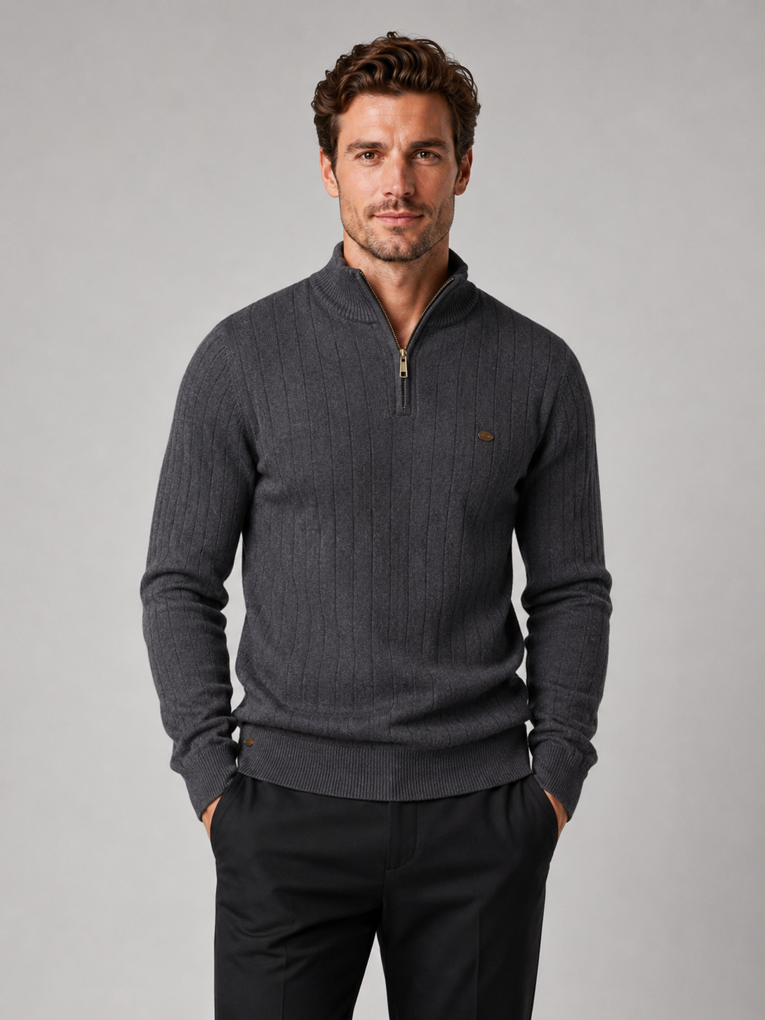 Front view of a man wearing a dark gray quarter zip pullover sweater with a stand collar, warm cotton knit, and long sleeves
