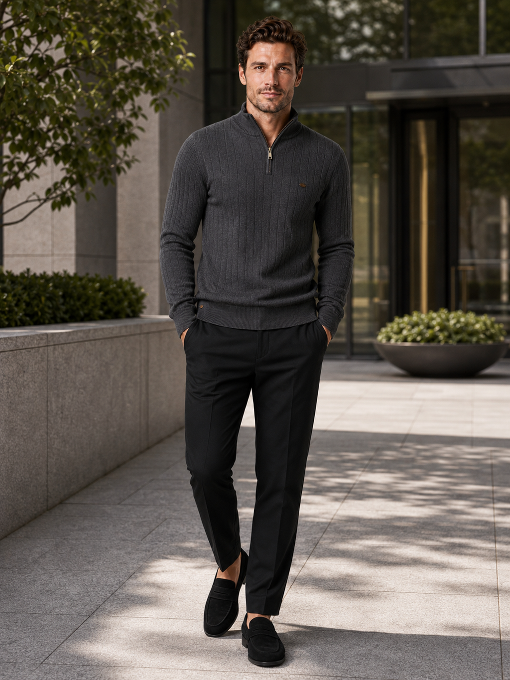 Man wearing a dark gray quarter zip cotton knit sweater in a business casual fall winter outfit for everyday wear