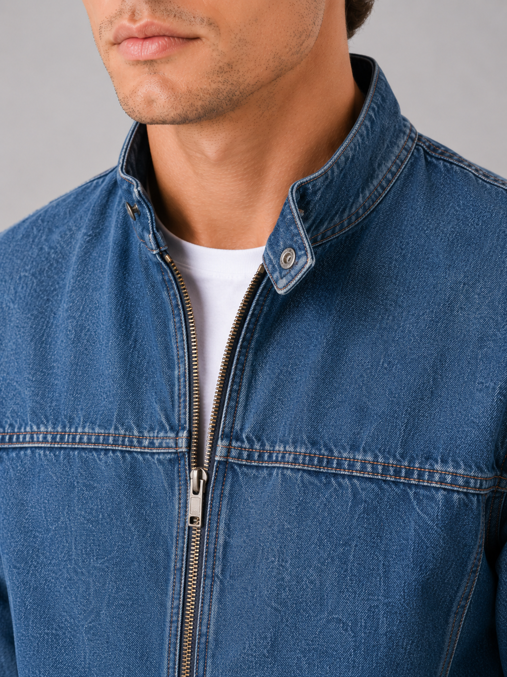Close up of denim workwear jacket showing durable denim fabric and zip up front detail