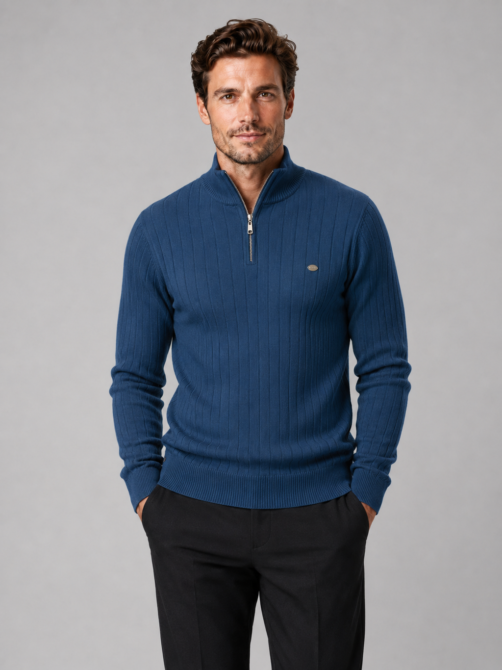 Front view of a man wearing a denim blue quarter zip pullover sweater with a stand collar, warm cotton knit, and long sleeves