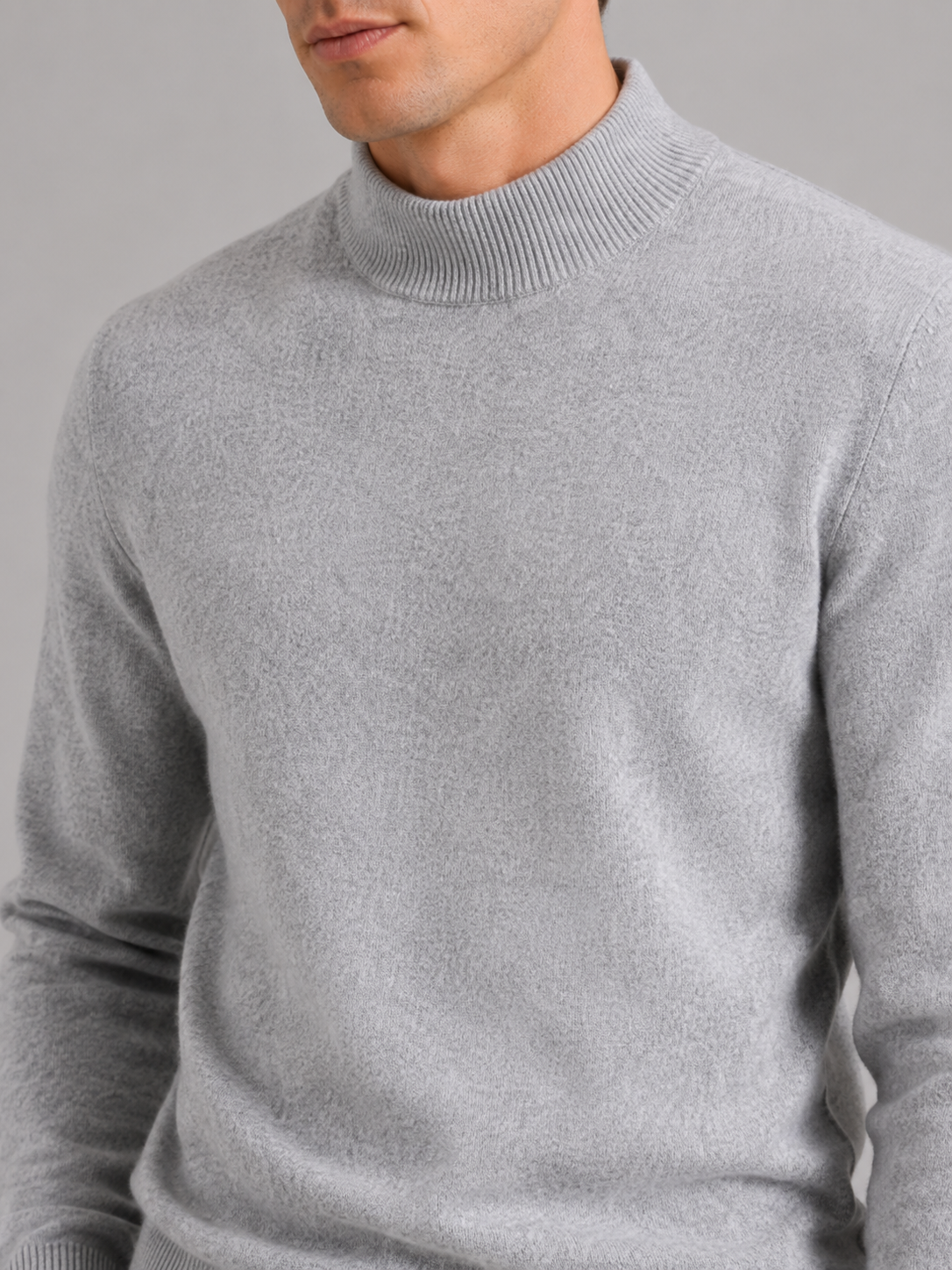 Close up of gray wool mock neck sweater showing soft premium knit texture and refined collar detail