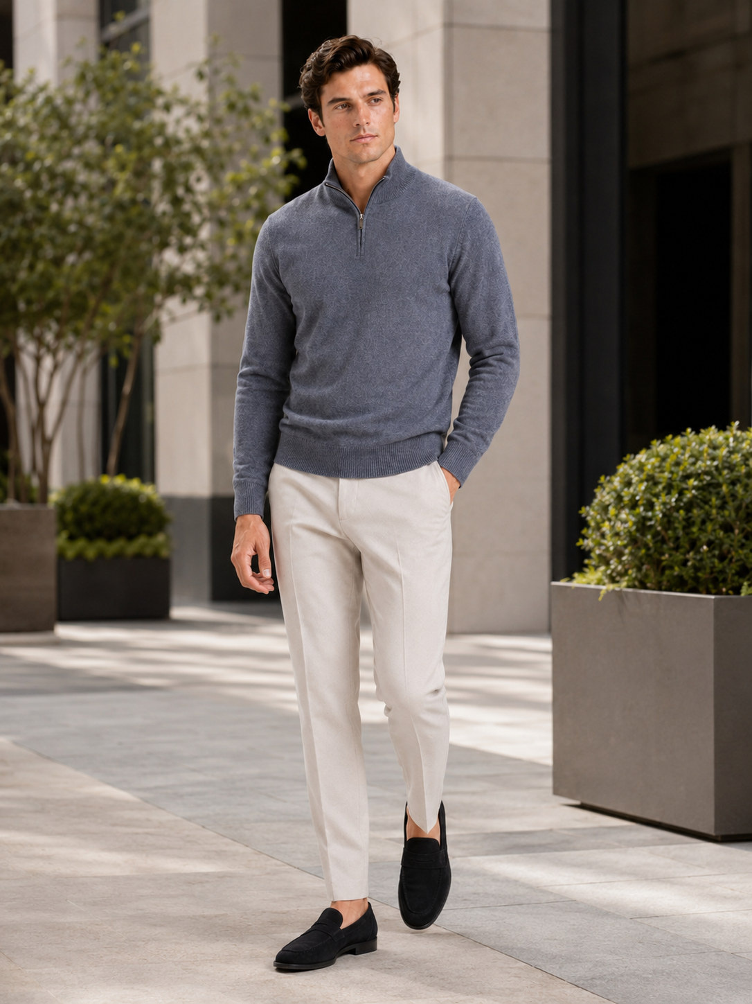 Man styling gray wool half zip mock neck sweater in a clean fall winter lifestyle outfit