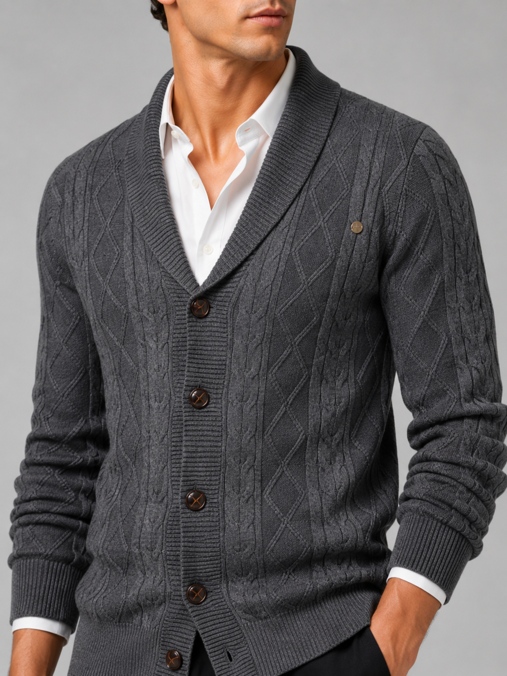 Close up of gray argyle cardigan showing cable knit texture and refined button front detail