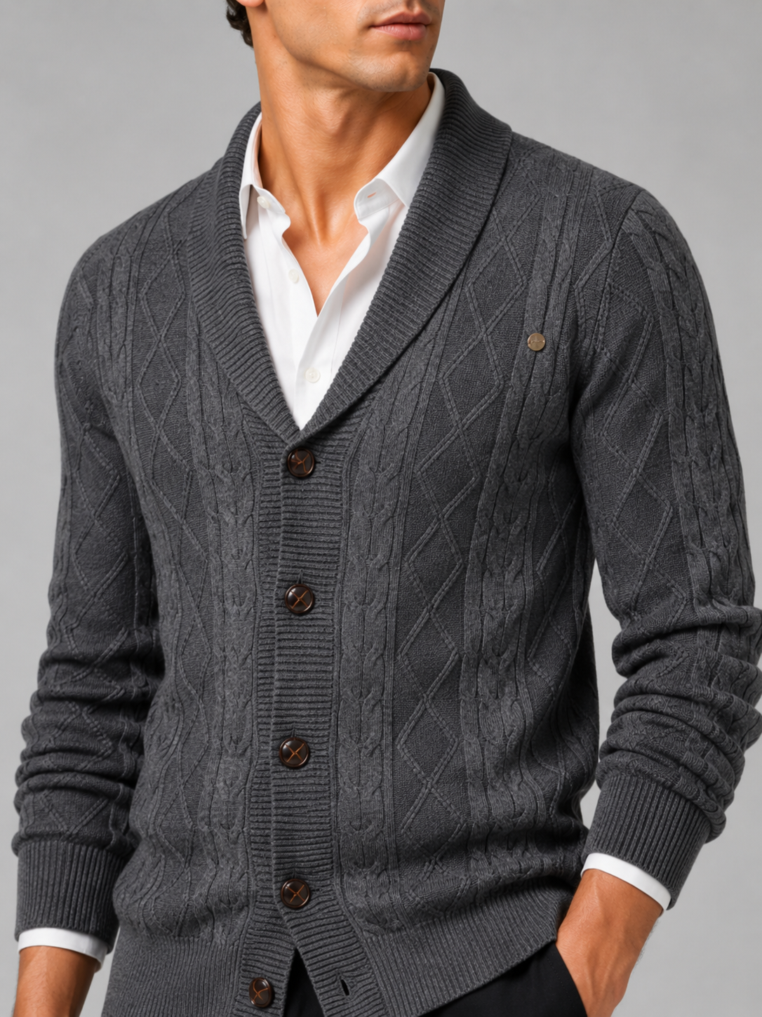 Close up of gray argyle cardigan showing cable knit texture and refined button front detail