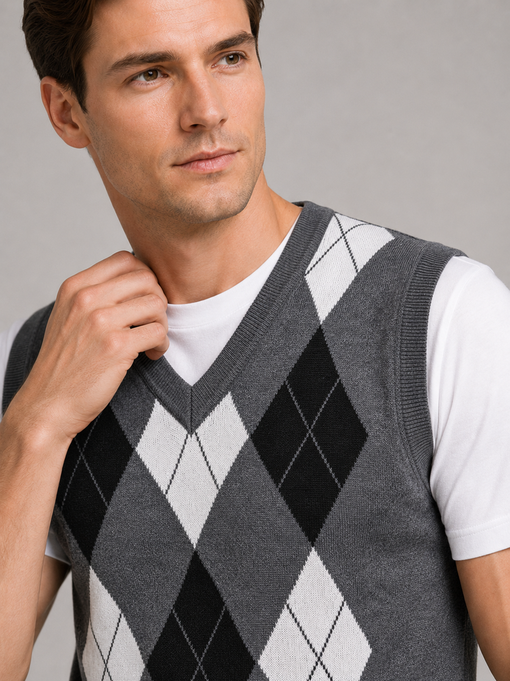 Close up of gray argyle sweater vest showing classic diamond knit pattern and refined v neck detail