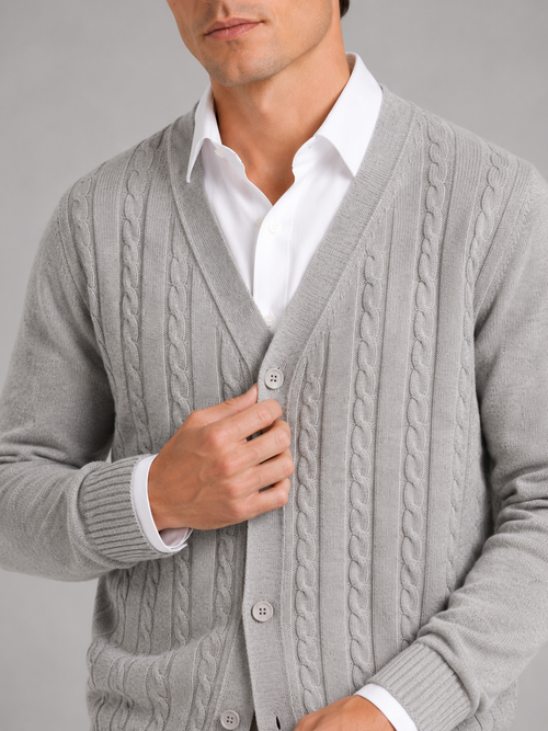 Close up of gray cable knit cardigan showing soft textured fabric and button front detail