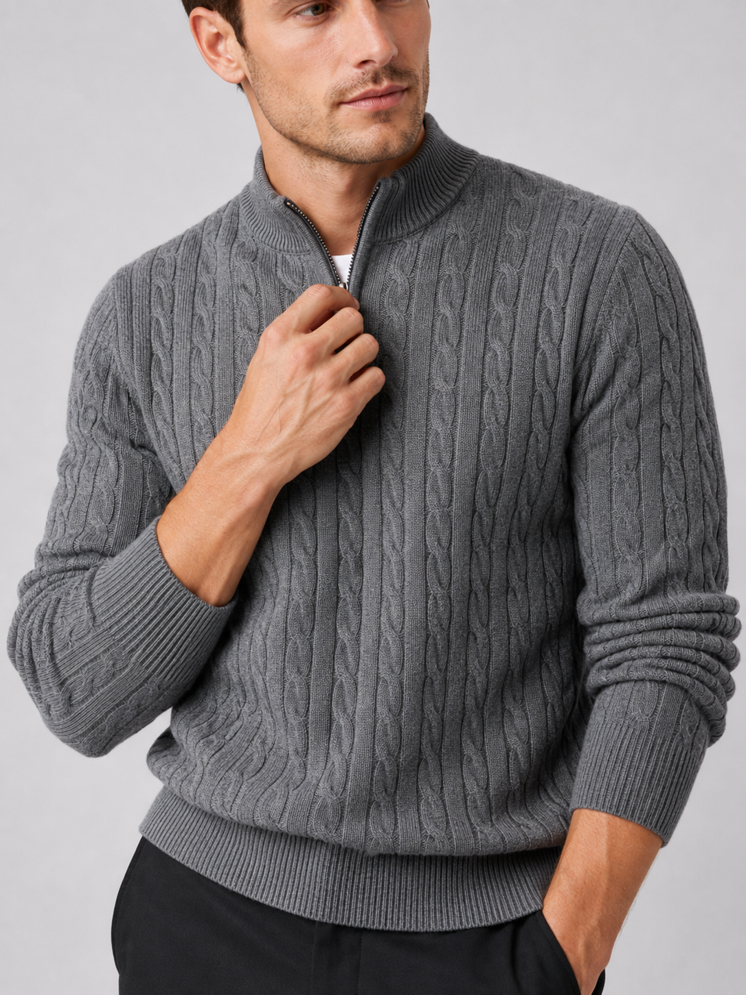 Close up of gray cable knit sweater showing textured pattern, mock neck, and quarter zip detail