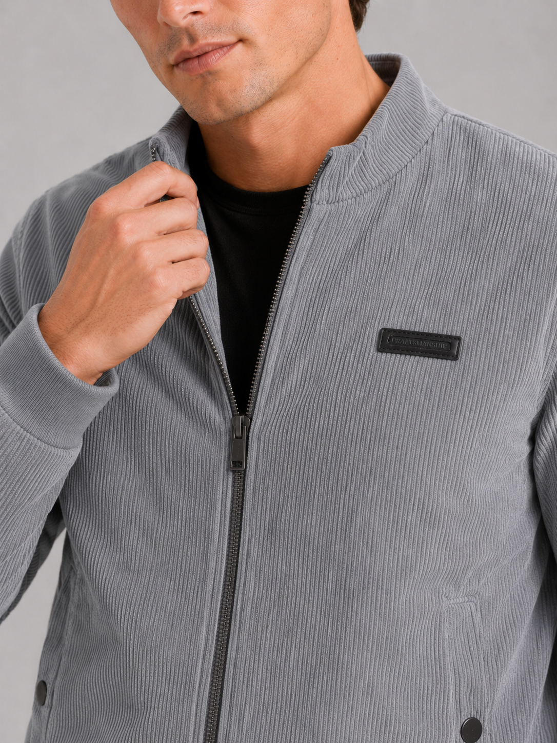 Close up of gray corduroy workwear jacket showing padded cotton fabric and textured corduroy detail