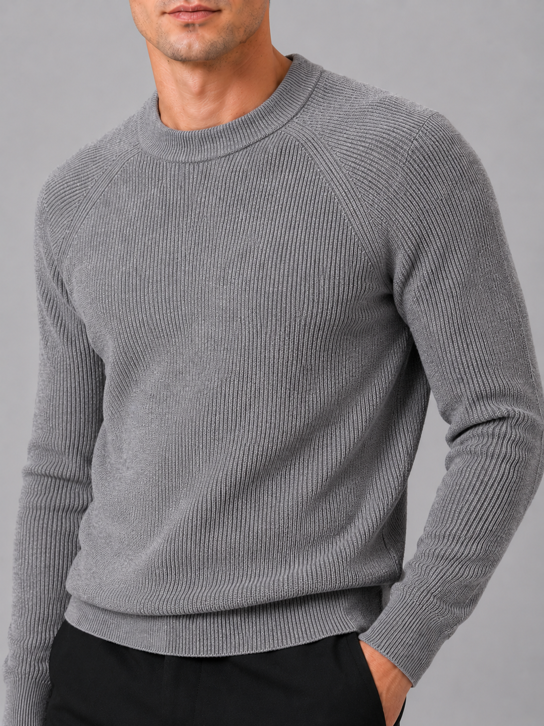 Close up of gray knit sweater showing thick soft fabric and classic crew neck detail