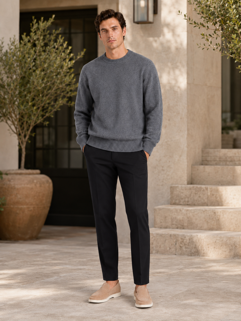 Man styling gray crewneck sweater in a clean everyday fall winter lifestyle outfit