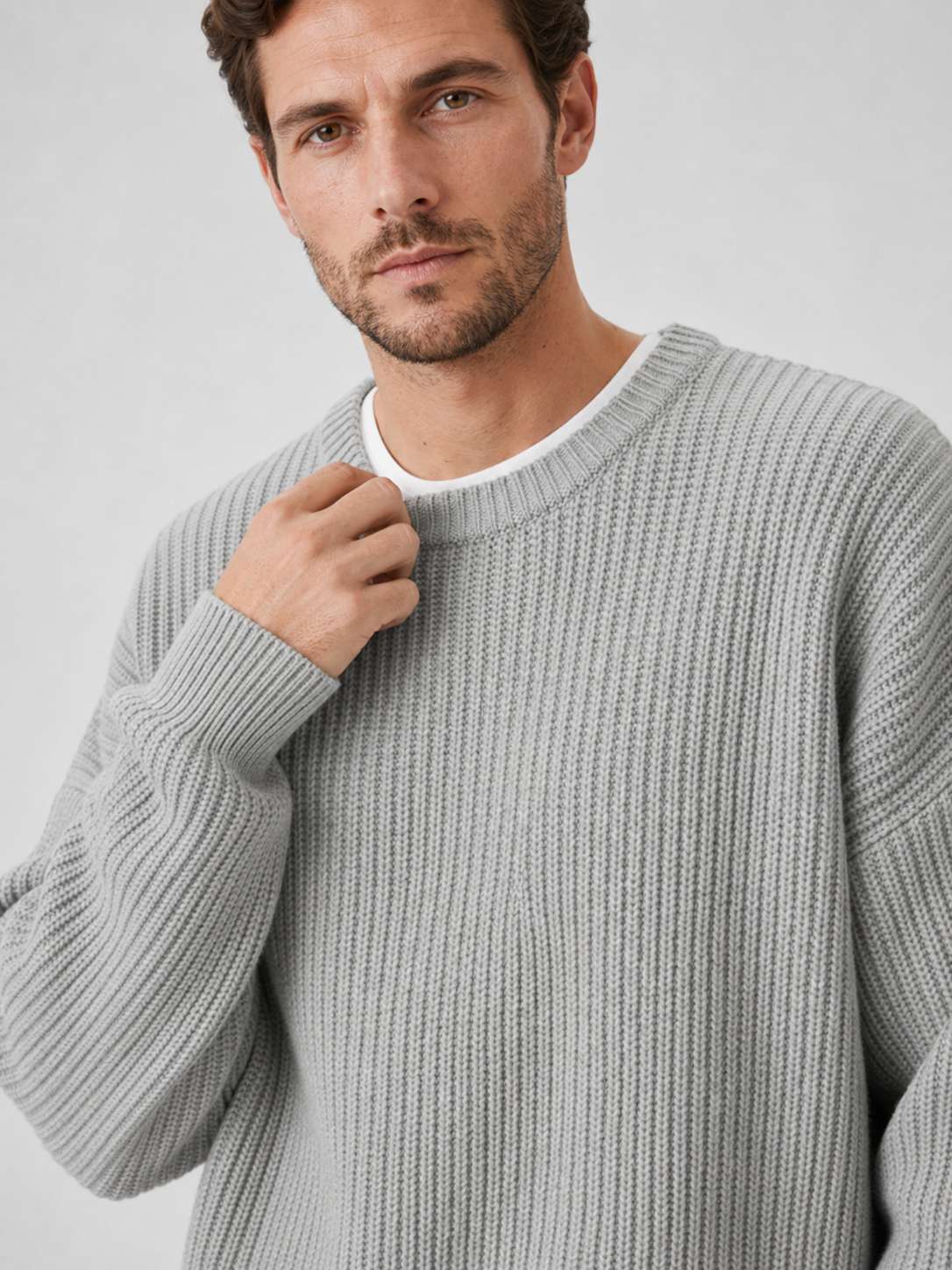 Close up of gray crewneck sweater showing soft knit texture and classic ribbed neckline detail