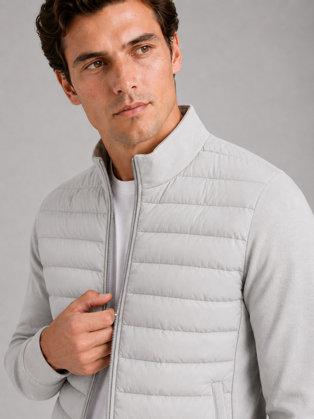 Close up of gray down jacket showing smooth padded fabric and stand collar detail