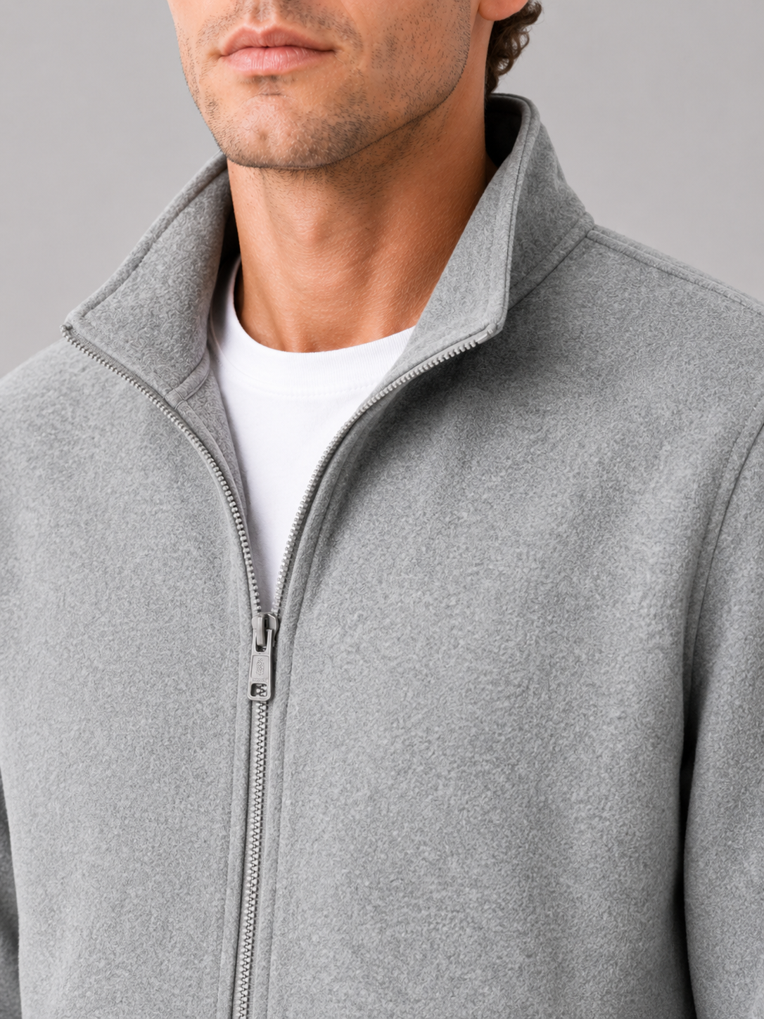 Close up of gray workwear jacket showing durable fabric and stand collar zipper detail