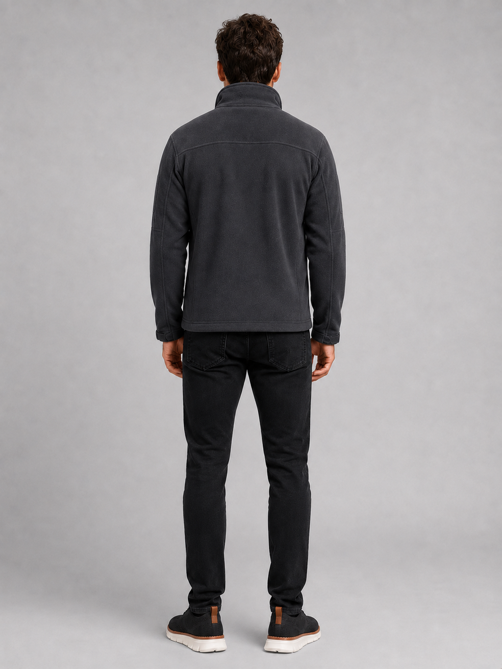 Back view of a man wearing a gray fleece jacket showing the warm fleece construction, long sleeves, and comfortable outdoor fit