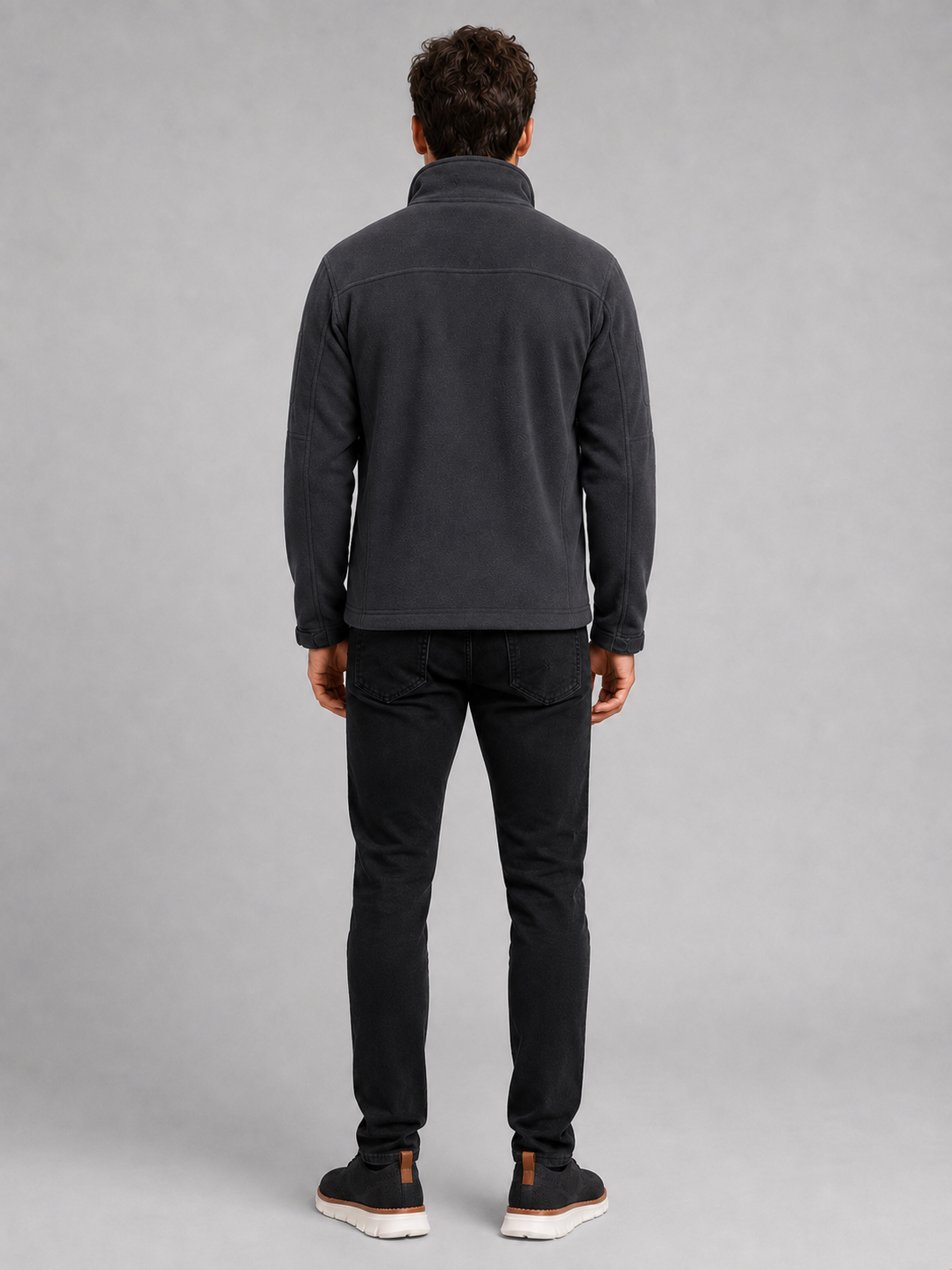 Back view of a man wearing a gray fleece jacket showing the warm fleece construction, long sleeves, and comfortable outdoor fit