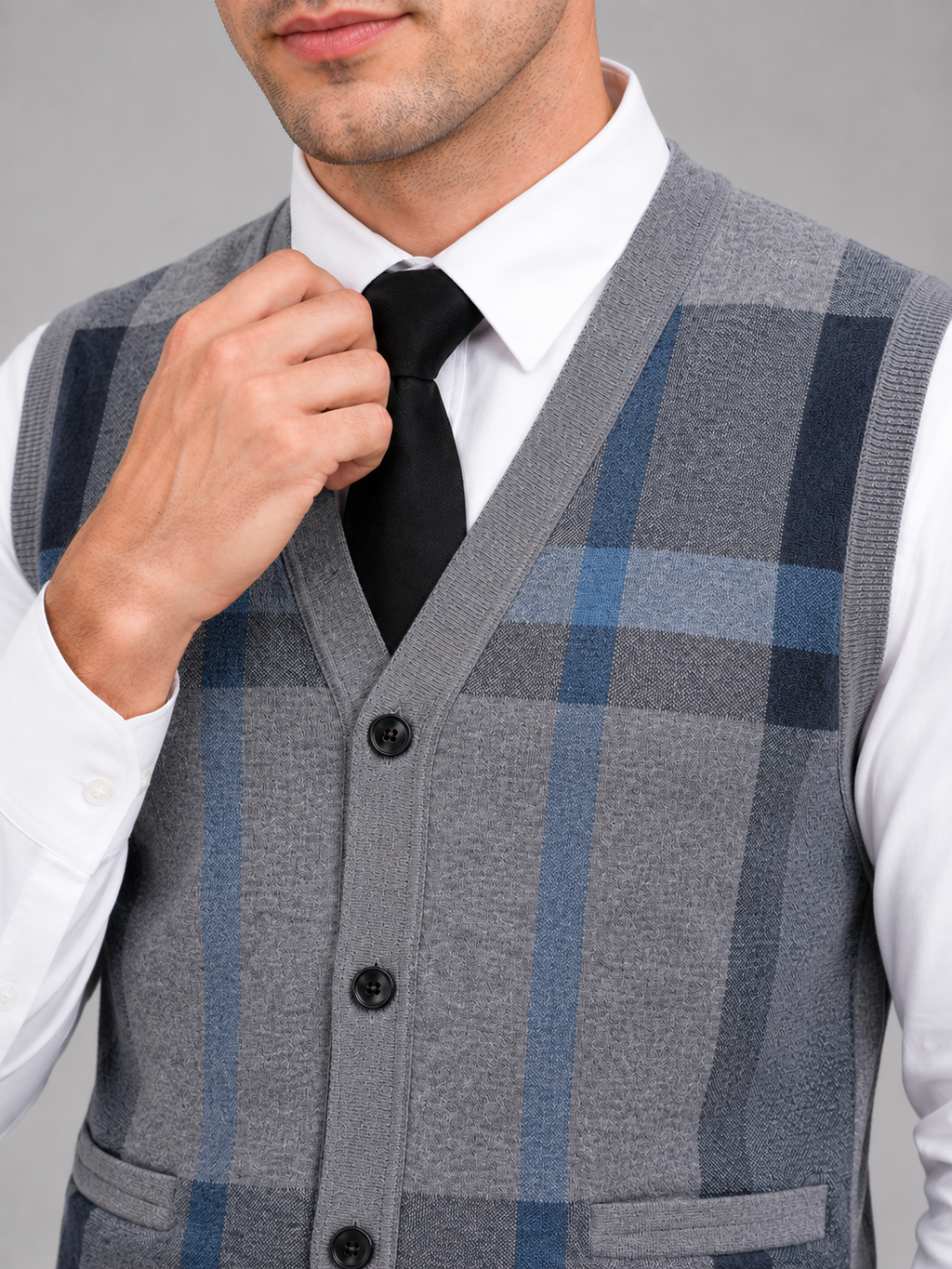 Close up of gray fleece sweater vest showing soft knit texture and button front detail