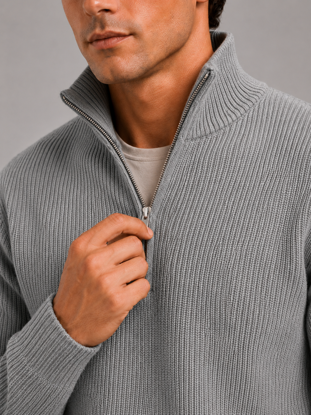 Close up of gray half zip sweater showing thick knit texture and refined zipper detail