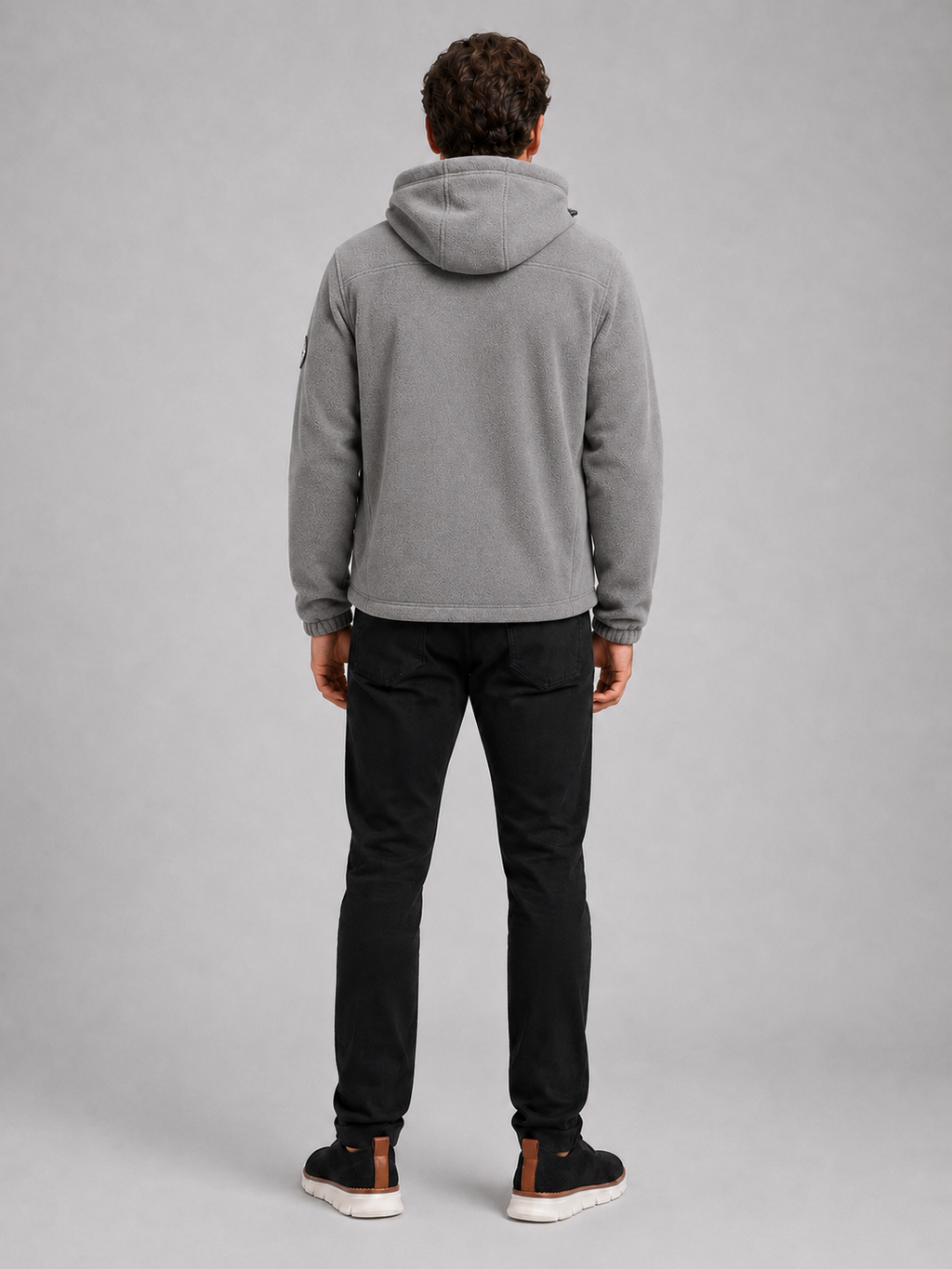 Back view of a man wearing a gray hooded fleece jacket showing the attached hood, thick fleece construction, long sleeves, and comfortable outdoor fit