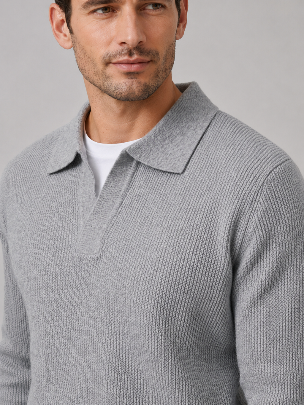 Close-up of a gray Johnny collar sweater showing the thick knit texture, open polo collar, cuffs, and stitching