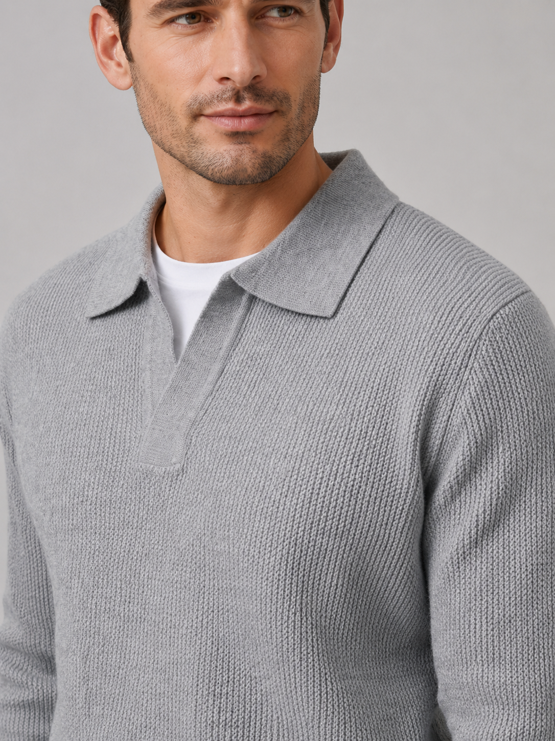 Close-up of a gray Johnny collar sweater showing the thick knit texture, open polo collar, cuffs, and stitching
