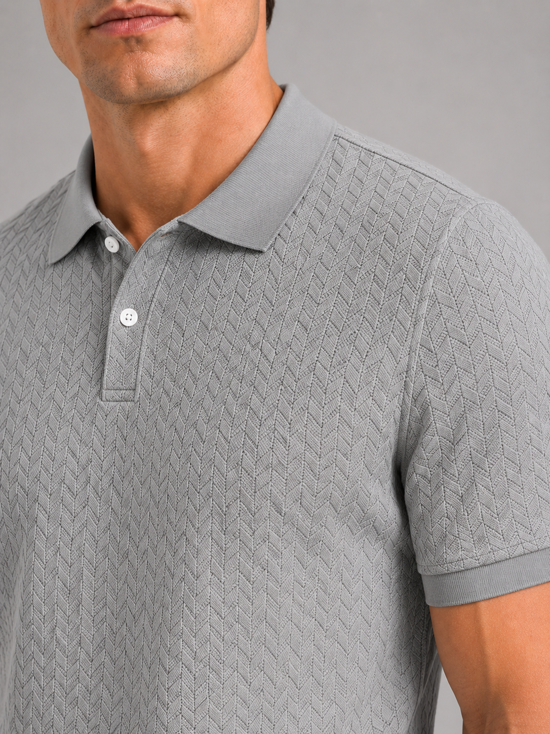 Close up of gray knit polo shirt showing soft breathable fabric and refined collar detail
